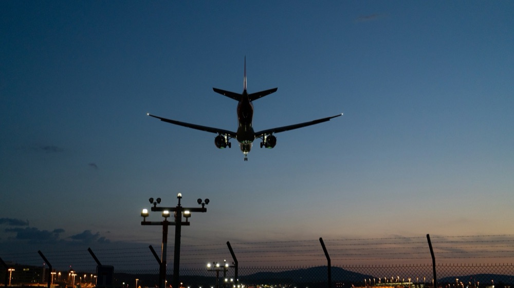 Aircraft approaching the runway at dusk